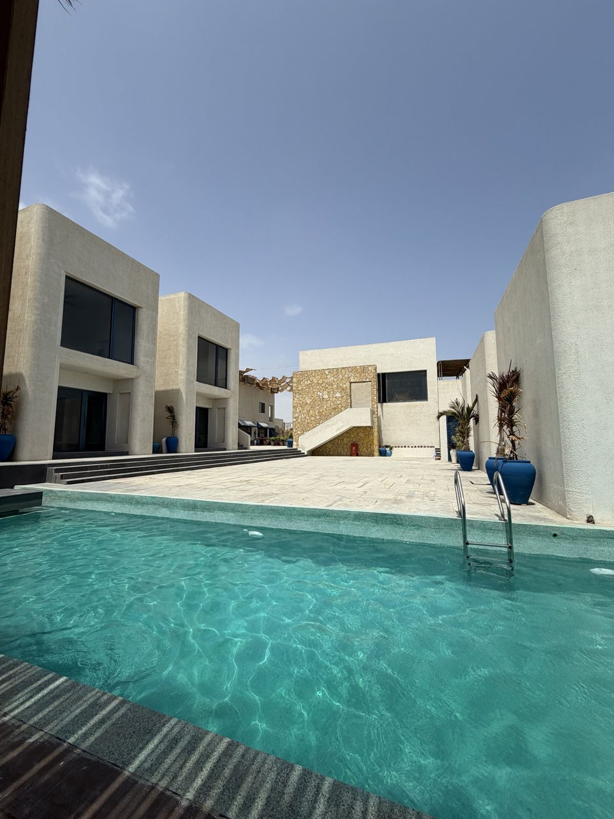 Pool courtyard framed by sculpted plaster architecture